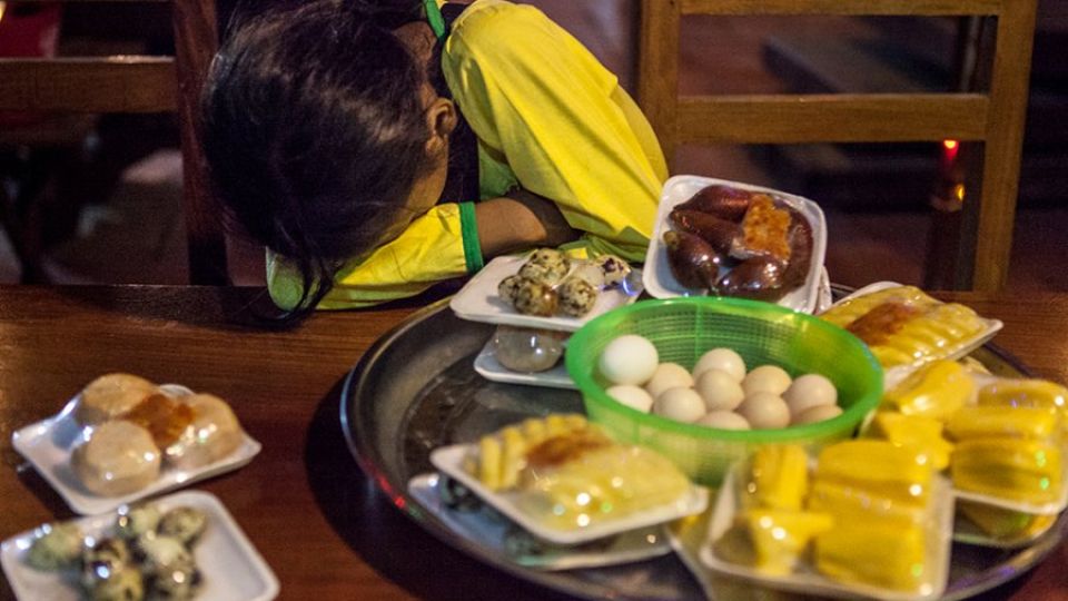 28_8_2024_a_child_rests_while_selling_fruit_at_a_bar_in_phnom_penh_s_toul_kork_district_post_staff.jpg