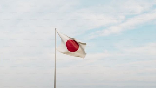 a-japanese-flag-flying-in-the-wind-on-a-cloudy-day-8NBNOg_dqfQ.jpg