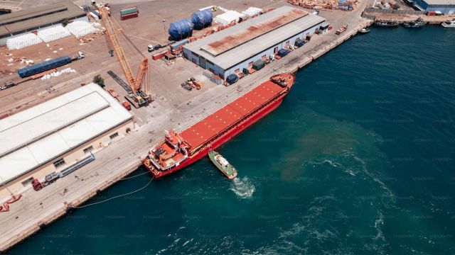a-large-red-boat-in-a-body-of-water-XxCAR6ujHLM.jpg