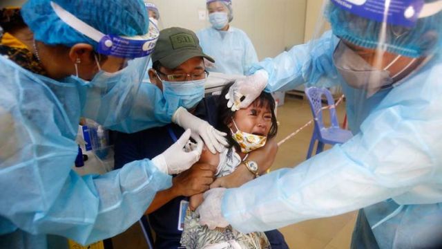 a_girl_receives_a_booster_shot_at_a_hospital_in_phnom_penhs_por_sen_chey_district_in_february._heng_chivoan.jpg