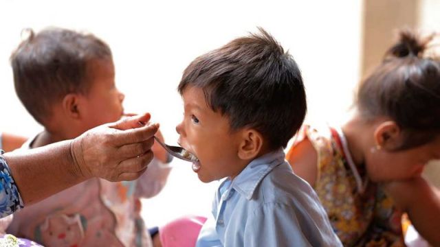 a_grandmother_feeds_her_grandson_in_kratie_province_in_may._hong_menea.jpg