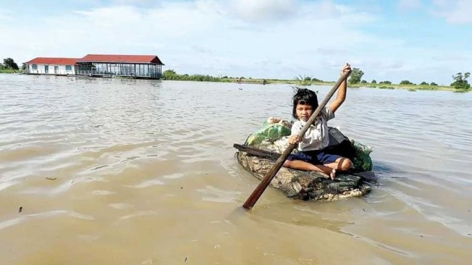 at_home_on_the_water_a_dedicated_student_displays_grit_and_determination_as_she_paddles_a_homemade_raft_to_her_floating_school_in_puok_district_of_siem_reap_province._fb.jpg