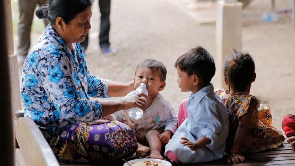 grandmother_takes_care_of_her_grandchildren_in_kratie_province_in.jpeg