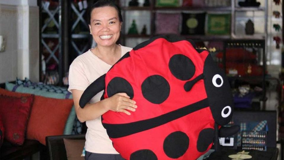 ky_kanary_-_the_founder_of_the_cambodia_womens_support_group_-_holds_a_plush_ladybug_sewn_by_a_member._supplied.jpg