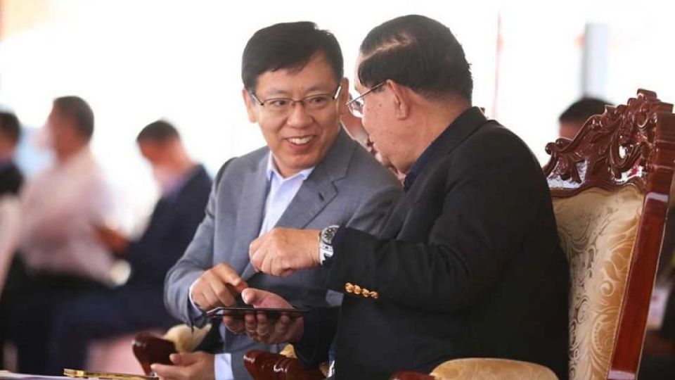 prime_minister_hun_sen_right_speaks_with_chinese_ambassador_wang_wentian_while_presiding_over_a_ceremony_marking_the_official_start_of_a_revamp_for_national_road_41_in_kandal_province_on_december_2.jpg