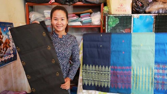 sar_san_holds_a_silk_skirt_she_made_on_koh_dach_in_the_capitals_chroy_changvar_district_last_month._hong_menea.jpg