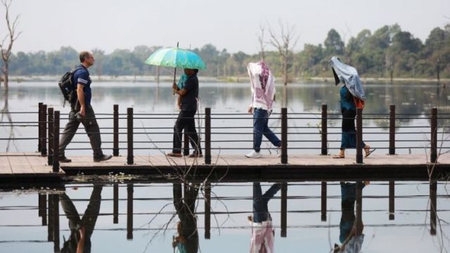 tourists-walk-on-a-bridge-crossing-a-moat-to-visit-neak-pean-temple-in-siem-reap-on-january-1.-hong-menea.jpg