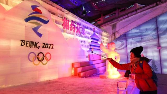 visitors_taking_photos_of_an_ice_sculpture_for_the_2022_beijing_winter_olympic_and_paralympic_games_in_beijing.jpeg